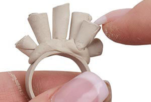 Clay cones being pressed onto ring